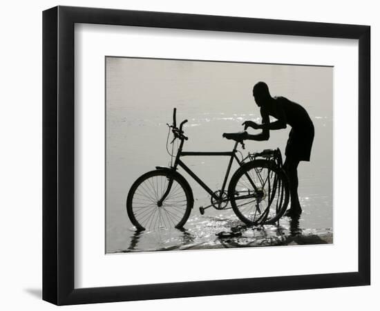 A Chadian Man Washes His Bicycle-null-Framed Photographic Print