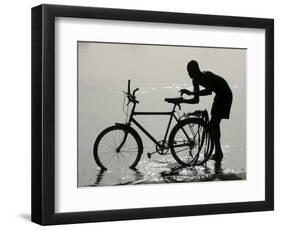 A Chadian Man Washes His Bicycle-null-Framed Photographic Print