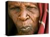 A Chadian Woman Made Homeless by Warfare Sits Near Her Hut-null-Stretched Canvas