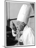 A Chef in a Chef's Hat Tastes Some Soup or Other Food from a Ladle-null-Mounted Photographic Print