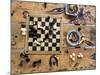 A Chess Board and Unemptied Ashtrays-null-Mounted Photographic Print