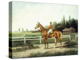 A Chestnut Racehorse with Jockey Up on a Training Track with Stables Beyond-Henry H. Cross-Stretched Canvas