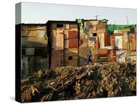 A Child Runs by a Row of Shacks in Novo Mundo Shantytown, Sao Paulo, Brazil-null-Stretched Canvas