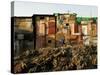 A Child Runs by a Row of Shacks in Novo Mundo Shantytown, Sao Paulo, Brazil-null-Stretched Canvas