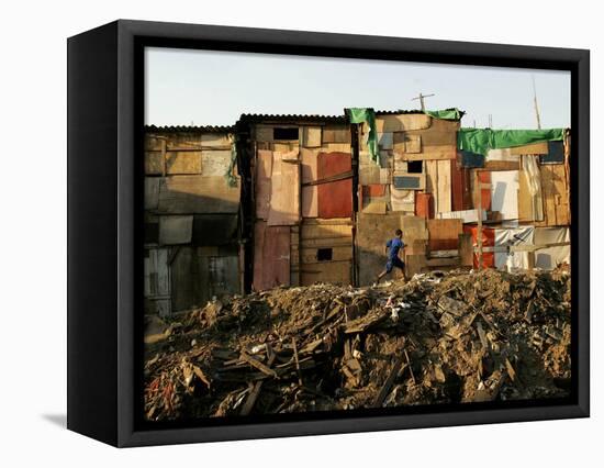 A Child Runs by a Row of Shacks in Novo Mundo Shantytown, Sao Paulo, Brazil-null-Framed Stretched Canvas