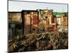 A Child Runs by a Row of Shacks in Novo Mundo Shantytown, Sao Paulo, Brazil-null-Mounted Photographic Print