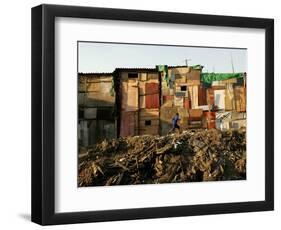 A Child Runs by a Row of Shacks in Novo Mundo Shantytown, Sao Paulo, Brazil-null-Framed Photographic Print