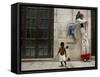 A Child Walks Past a Dancer of Giganteria's Group-null-Framed Stretched Canvas