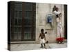 A Child Walks Past a Dancer of Giganteria's Group-null-Stretched Canvas