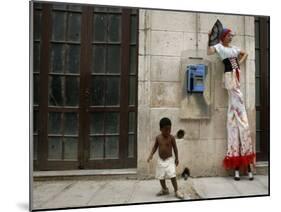 A Child Walks Past a Dancer of Giganteria's Group-null-Mounted Photographic Print