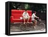 A Chinese Man Rides on a Sofa as Another Pedals a Delivery Tricycle-null-Framed Stretched Canvas
