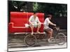 A Chinese Man Rides on a Sofa as Another Pedals a Delivery Tricycle-null-Mounted Photographic Print