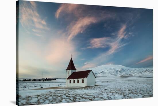 A church in the winter in western Iceland at sunset.-Alex Saberi-Stretched Canvas