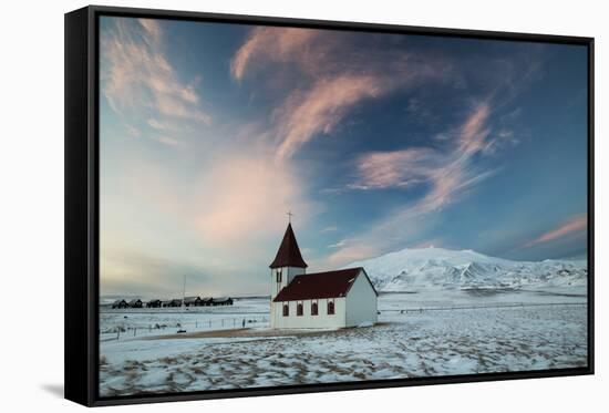 A church in the winter in western Iceland at sunset.-Alex Saberi-Framed Stretched Canvas