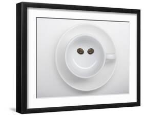 A Coffee Cup with Two Coffee Beans Making a Smiley Face-Jean Gillis-Framed Photographic Print