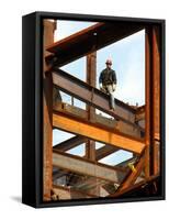 A Construction Worker Stands on a Steel Beam While Working on a High Rise Building-null-Framed Stretched Canvas
