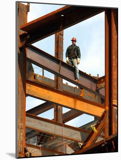 A Construction Worker Stands on a Steel Beam While Working on a High Rise Building-null-Mounted Photographic Print