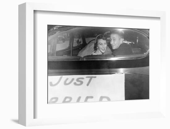 A Couple Peers Out of the Back Window on their Wedding Day, Ca. 1953-null-Framed Photographic Print