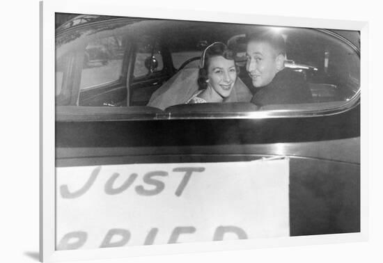 A Couple Peers Out of the Back Window on their Wedding Day, Ca. 1953-null-Framed Photographic Print