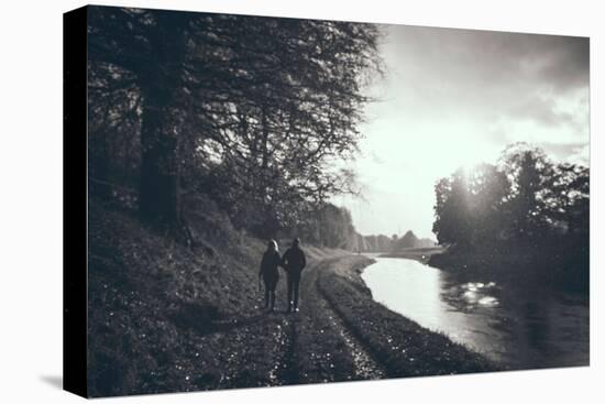 A Couple Walking Along a Canal on a Wet Day-Clive Nolan-Stretched Canvas