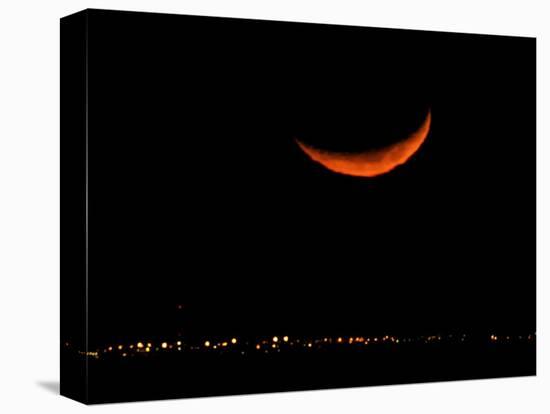 A Crescent Moon Dwarfs the Lights of Fort Riley Army Base in Central Kansas, January 22, 2007-Charlie Riedel-Stretched Canvas