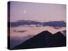 A Crescent Moon Rises over Clouds and Mountains at Twilight in Glacier Peak Wilderness, Washington.-Ethan Welty-Stretched Canvas