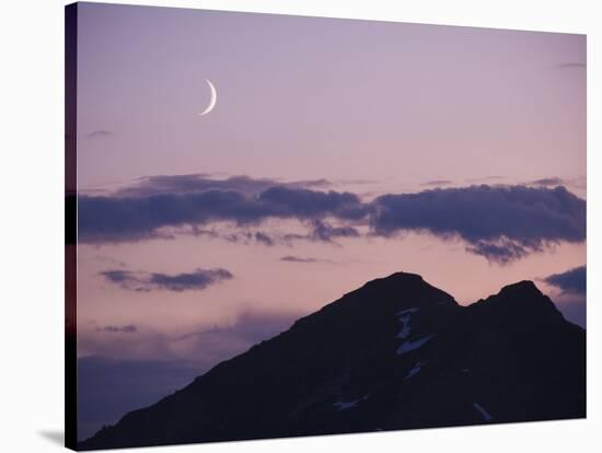 A Crescent Moon Rises over Clouds and Mountains at Twilight in Glacier Peak Wilderness, Washington.-Ethan Welty-Stretched Canvas