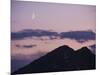 A Crescent Moon Rises over Clouds and Mountains at Twilight in Glacier Peak Wilderness, Washington.-Ethan Welty-Mounted Photographic Print