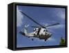 A Crew Chief Looks Out the Side Door of a Helicopter in Flight-null-Framed Stretched Canvas