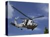 A Crew Chief Looks Out the Side Door of a Helicopter in Flight-null-Stretched Canvas