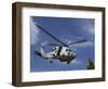 A Crew Chief Looks Out the Side Door of a Helicopter in Flight-null-Framed Photographic Print