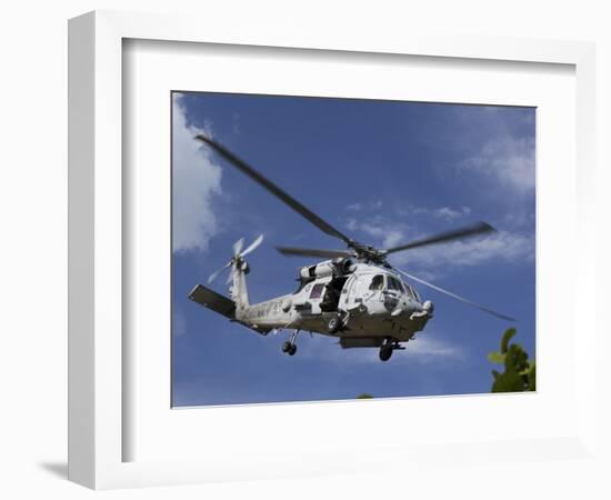 A Crew Chief Looks Out the Side Door of a Helicopter in Flight-null-Framed Photographic Print