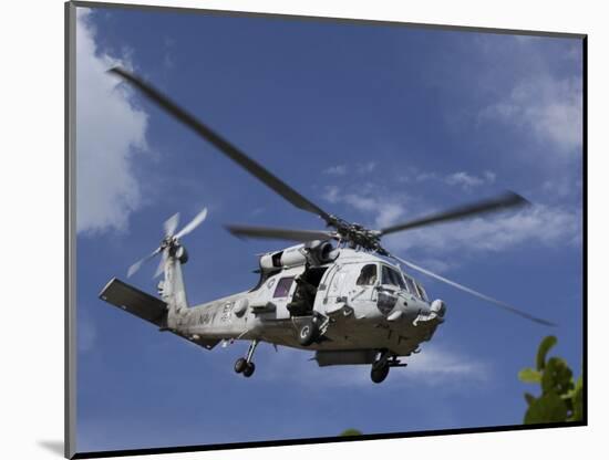 A Crew Chief Looks Out the Side Door of a Helicopter in Flight-null-Mounted Photographic Print