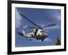 A Crew Chief Looks Out the Side Door of a Helicopter in Flight-null-Framed Photographic Print