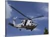 A Crew Chief Looks Out the Side Door of a Helicopter in Flight-null-Stretched Canvas