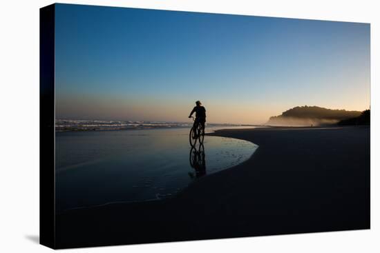 A Cyclist on Juquehy Beach at Sunset-Alex Saberi-Stretched Canvas