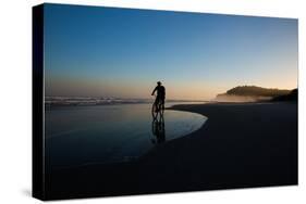 A Cyclist on Juquehy Beach at Sunset-Alex Saberi-Stretched Canvas
