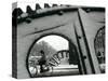 A Cyclist Passes a Draw Bridge as Snow Covers the City Center of Amsterdam-null-Stretched Canvas