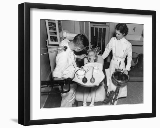 A Dentist Examining a Young Girl's Teeth in 1942-null-Framed Photo