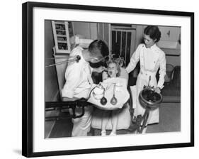 A Dentist Examining a Young Girl's Teeth in 1942-null-Framed Photo