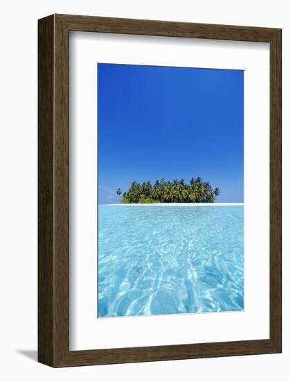 A deserted tropical island covered with palm trees amidst calm turquoise water.-Stuart Westmorland-Framed Photographic Print