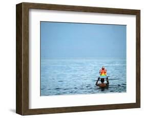 A Devotee Immerses the Idol of Elephant-Headed Hindu God Ganesh-null-Framed Photographic Print