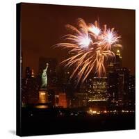 A Display of Fireworks Illuminates the Sky Near the Statue of Liberty-null-Stretched Canvas