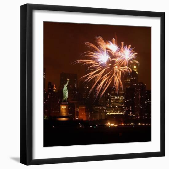 A Display of Fireworks Illuminates the Sky Near the Statue of Liberty-null-Framed Photographic Print