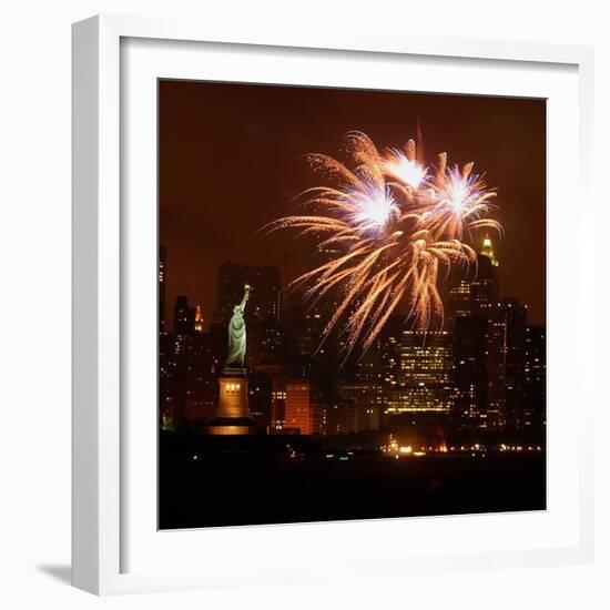 A Display of Fireworks Illuminates the Sky Near the Statue of Liberty-null-Framed Photographic Print