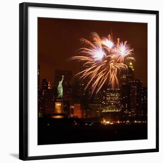 A Display of Fireworks Illuminates the Sky Near the Statue of Liberty-null-Framed Photographic Print