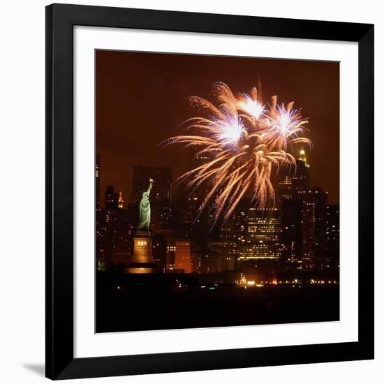 A Display of Fireworks Illuminates the Sky Near the Statue of Liberty-null-Framed Photographic Print