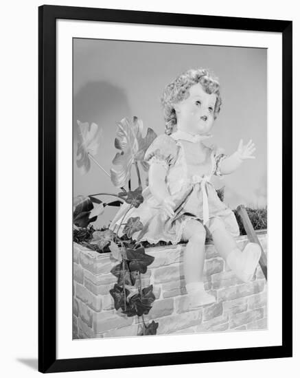 A Doll Sitting on a Wall-null-Framed Photographic Print