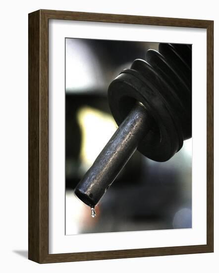 A Drip of Gas Falls from Nozzle at a Gasoline Station-null-Framed Photographic Print