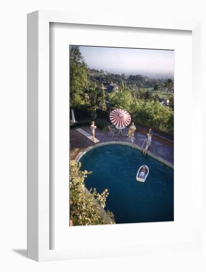 A Family at their Backyard Swimming Pool, in Foreground a Floating Rowboat with Boy Aboard-Frank Scherschel-Framed Photographic Print